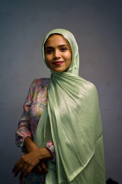 Woman wearing Dark Sea Green shimmer hijab with soft draped styling