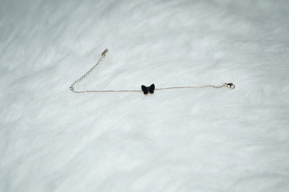 Dual Sided Butterfly Bracelet shown with the black side facing out against a soft background.