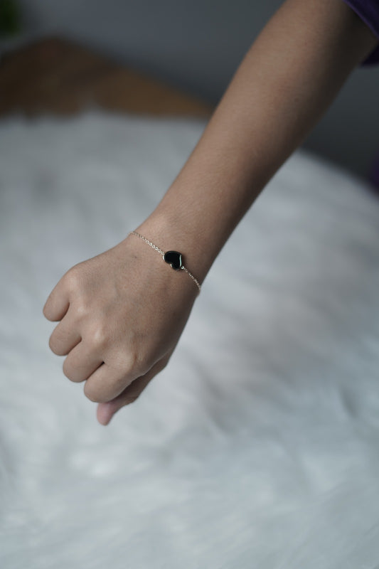 Close view of the black heart side, showing its glossy, smooth surface.