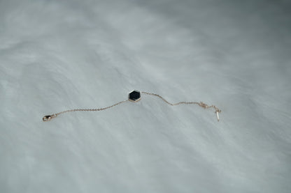 Dual Sided Hexa Bracelet captured with the black side of the hexagon charm in focus.