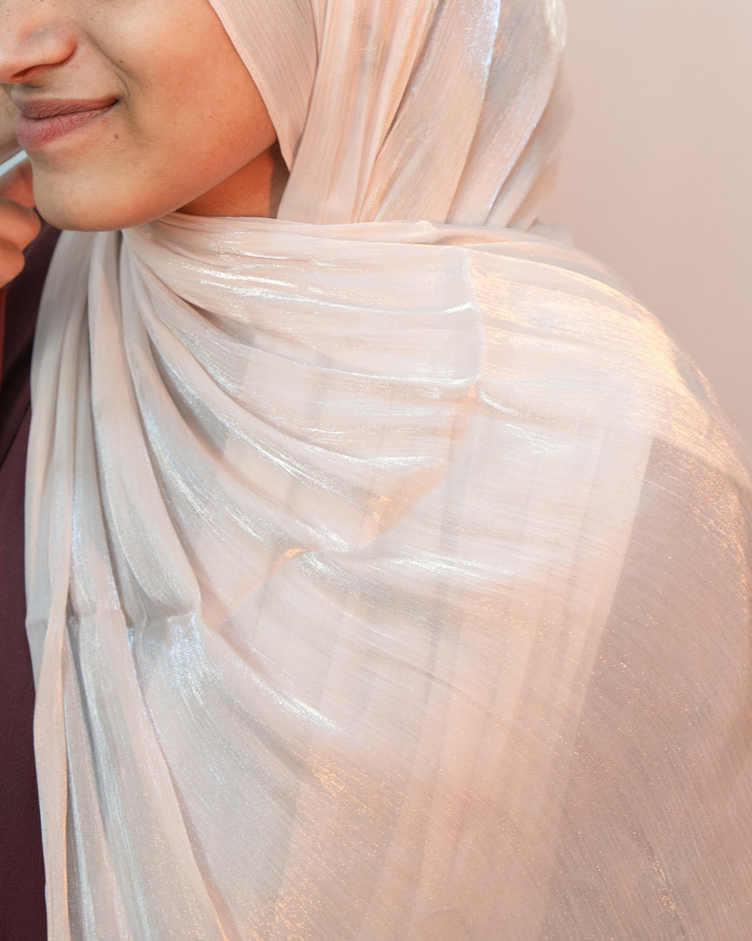 Close up dusty pink shimmer hijab smooth texture lightweight elegant modest scarf.