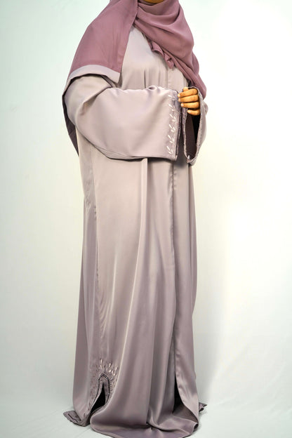 A side view of a woman wearing the Tiktok Indonesian Abaya, highlighting the flow of the silky fabric.