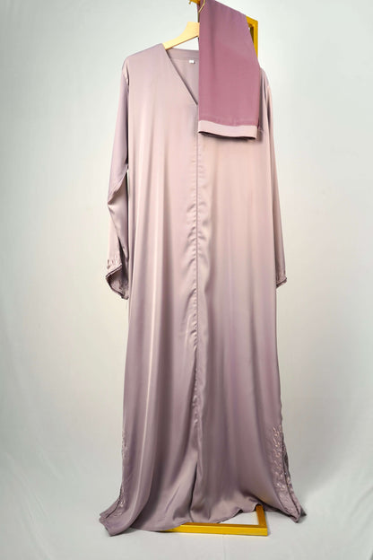 he Tiktok Indonesian Abaya in dusty purple, hanging with its matching scarf to showcase the full design and color.