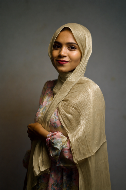 Woman wearing Golden Olive shimmer hijab with elegant draped styling