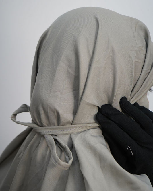 Adjustable back tie detail of gray polyester lycra prayer dress.