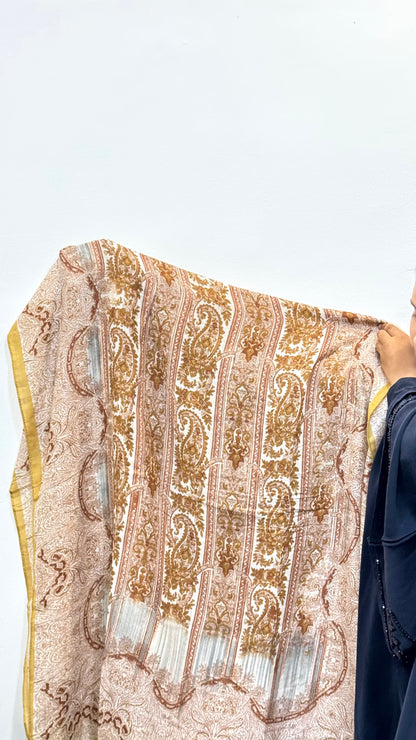 Detailed view of honey yellow pashmina material with visible print design and smooth finish.
