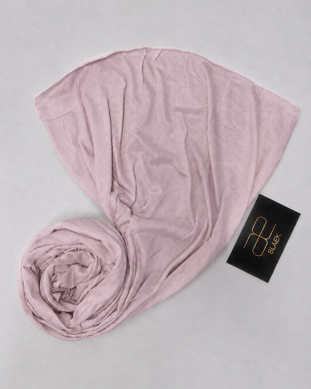 Dusty Mauve kids jersey hijab neatly rolled and displayed on a white background
