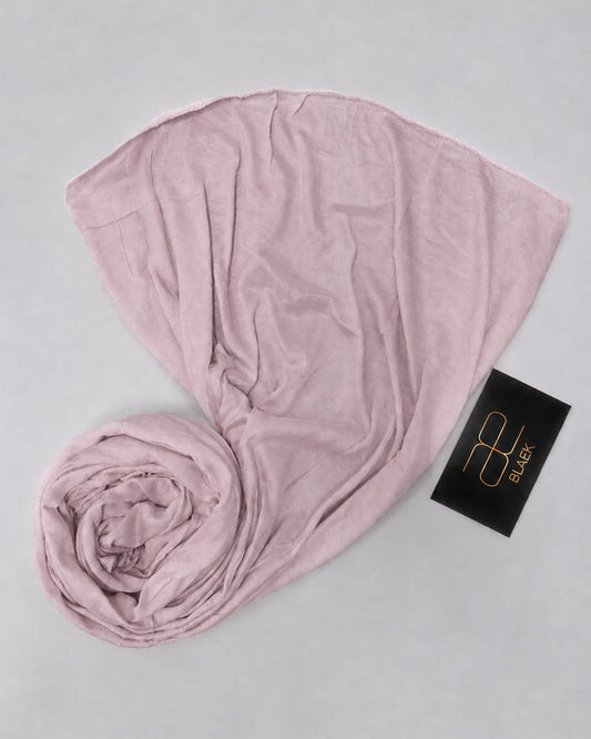 Dusty Mauve kids jersey hijab neatly rolled and displayed on a white background