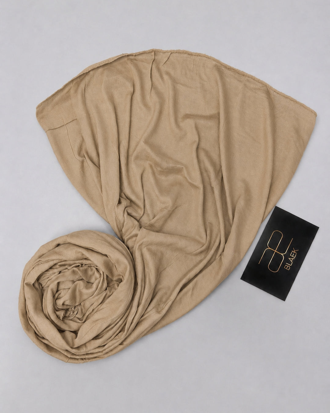 Soft taupe kids jersey hijab neatly displayed to show its smooth drape and natural fabric texture