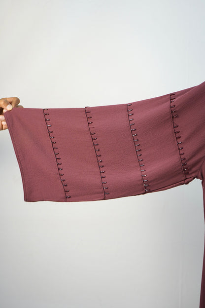 A detailed close-up of the unique studded design on the sleeves of the korean bubble abaya.