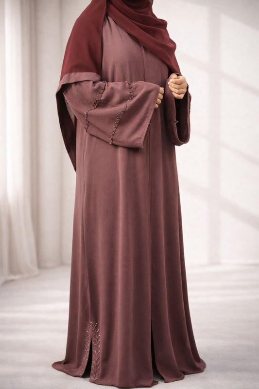 A woman wearing the Korean Bubble Abaya in Old Mauve, showcasing its elegant fit and flow.