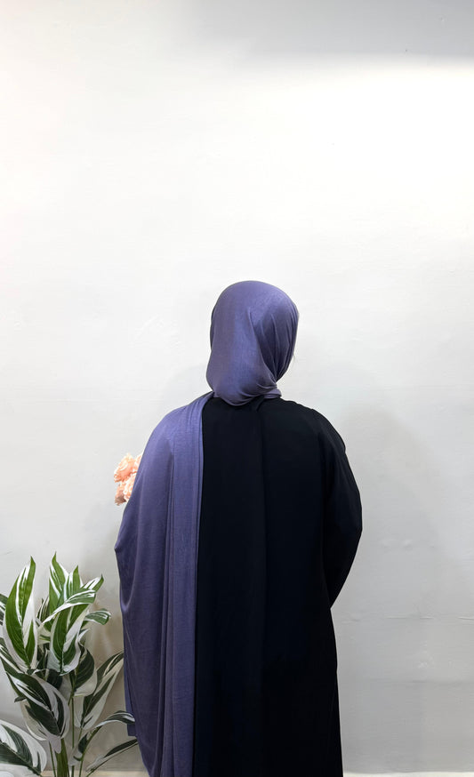 Woman in liberty jersey hijab styled over shoulder.