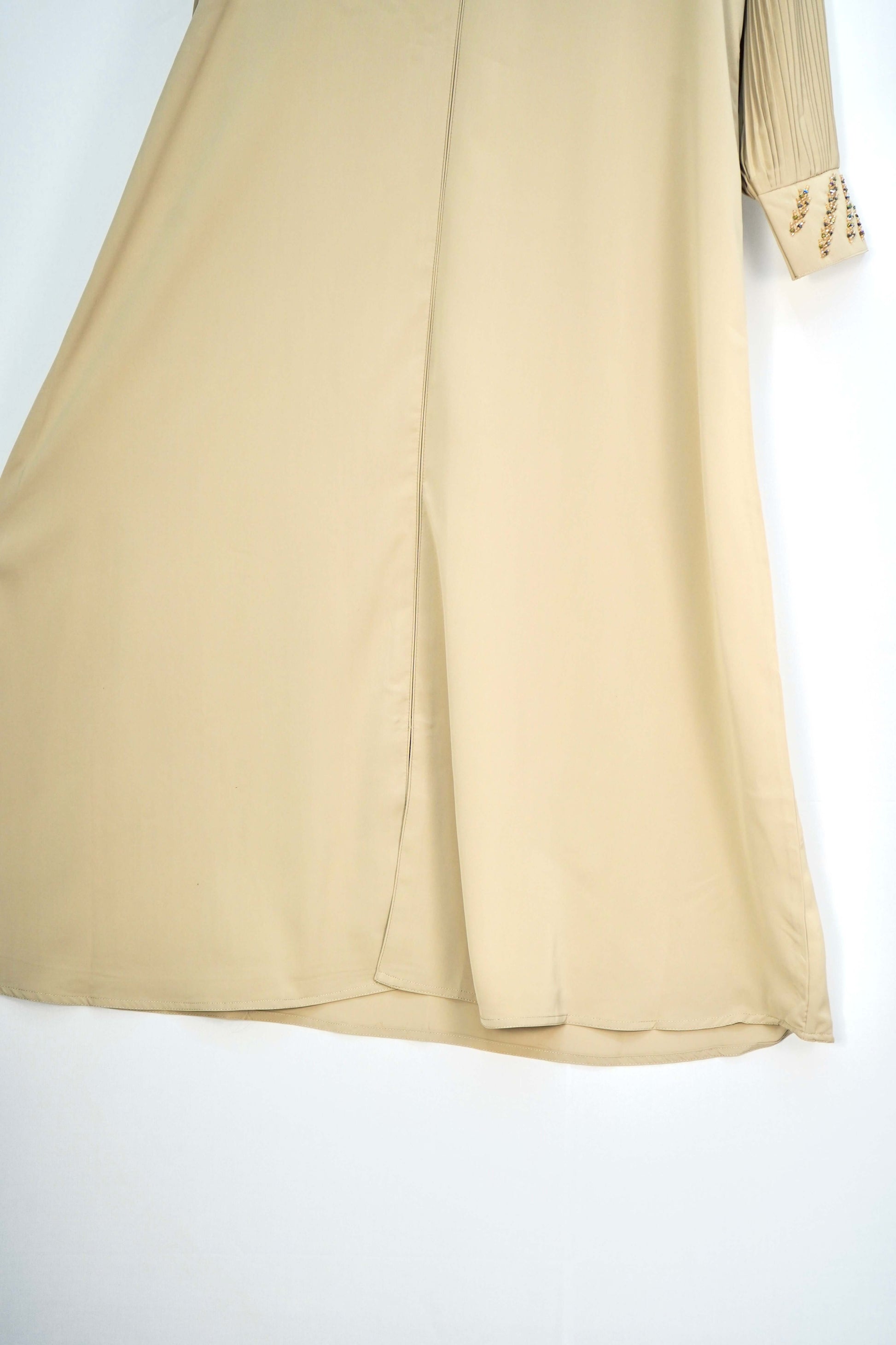 A close-up shot of the silky fabric of the abaya, showing its smooth texture and sheen.