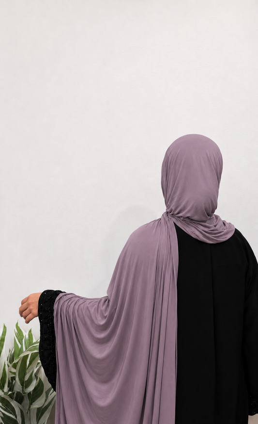 Woman wearing a Mauve Jersey Hijab with soft drape and full coverage