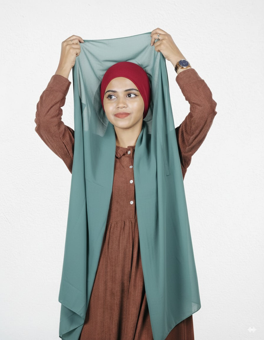 Mint green instant hijab with cherry cap, premium chiffon, worn style.