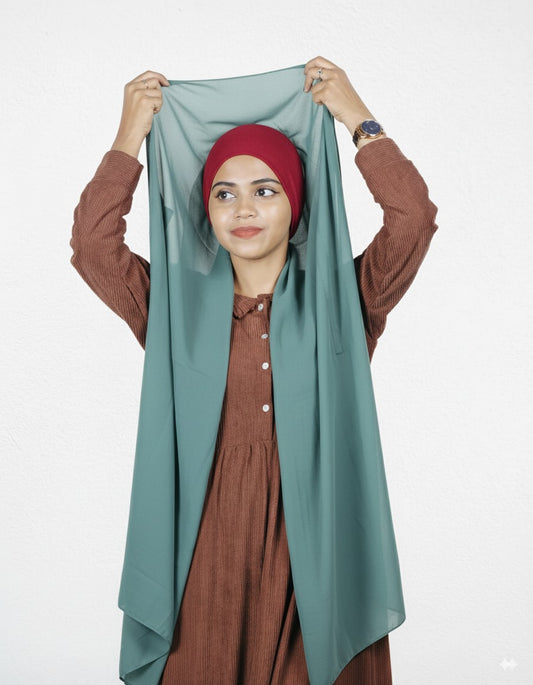 Mint green instant hijab with cherry cap, premium chiffon, worn style.