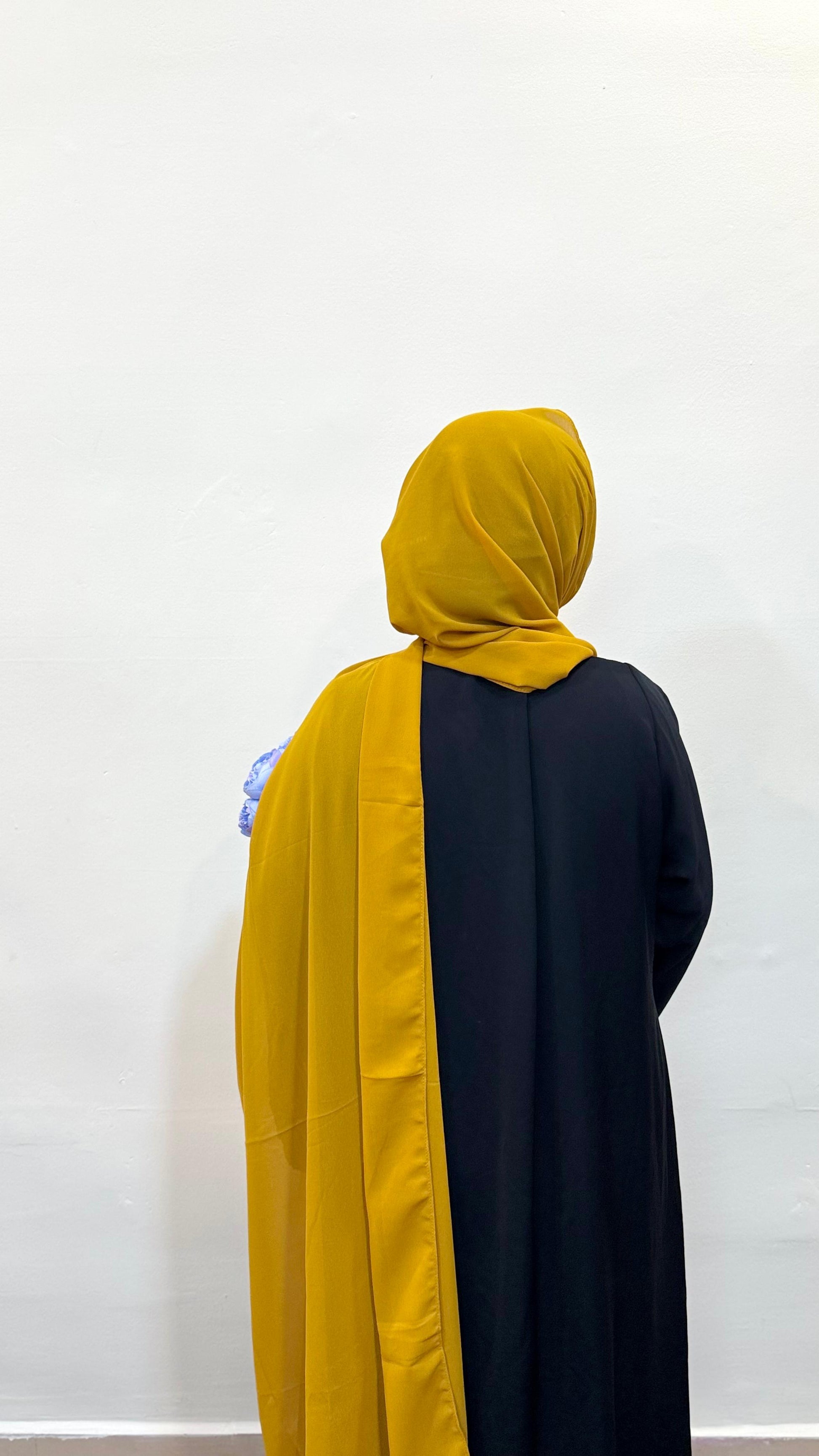 Bold mustard-colored chiffon hijab for a vibrant, elegant look.