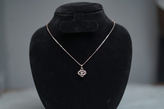 Orbit-inspired necklace on stand for jewelry showcase.