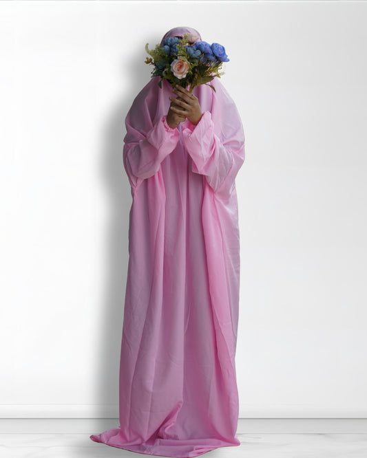 Solid pink prayer dress full length front view with floral bouquet.