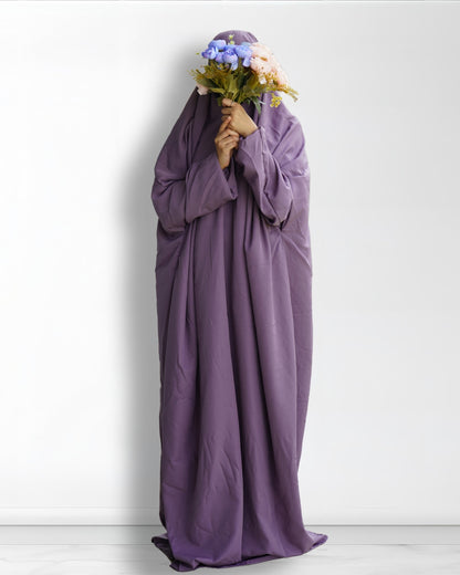 Solid purple prayer dress full length front view with floral bouquet.