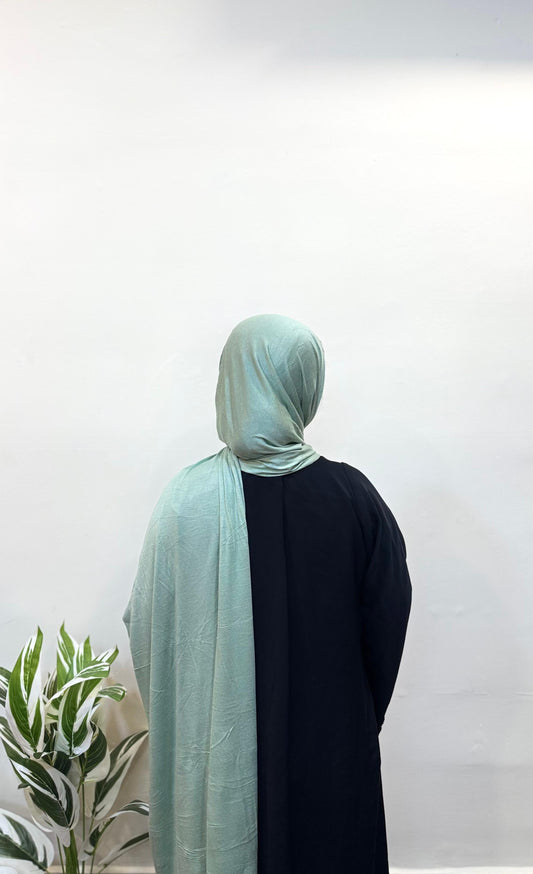 Seafoam green jersey hijab adding a refreshing touch to the look.