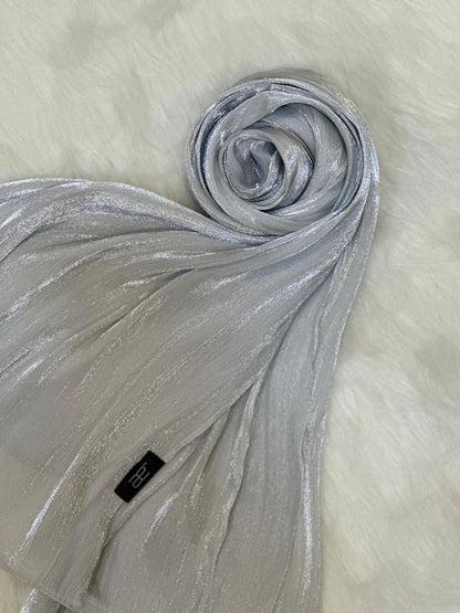 Round display of a silver chiffon scarf with light shimmer texture.