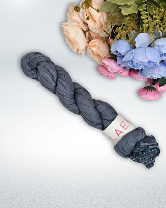 Slate Grey Cotton Hijab neatly braided with tassel ends.