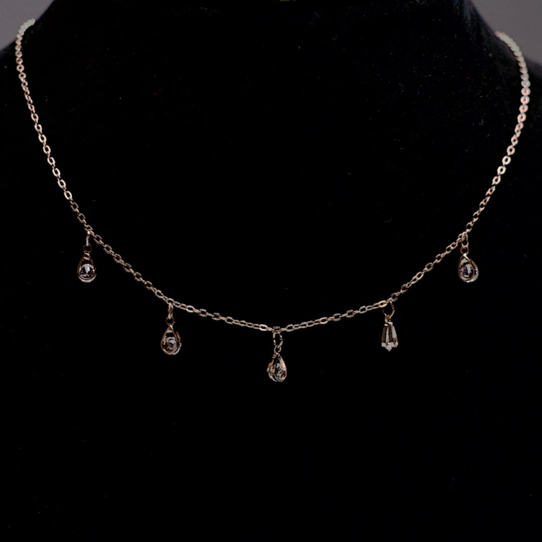 Rose gold stone drop chain necklace with five clear crystal teardrops.