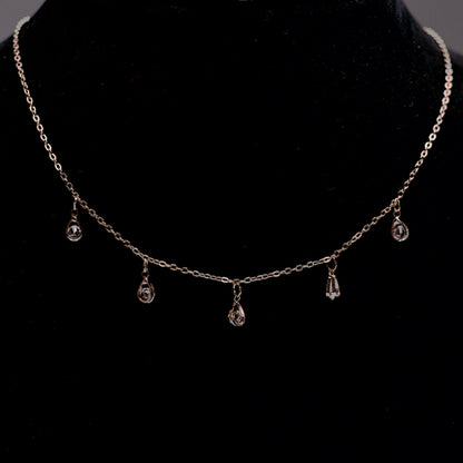 Rose gold stone drop chain necklace with five clear crystal teardrops.