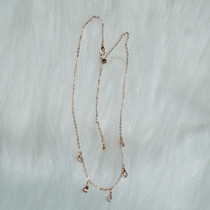 Rose gold stone drop chain necklace with five clear crystal teardrops.