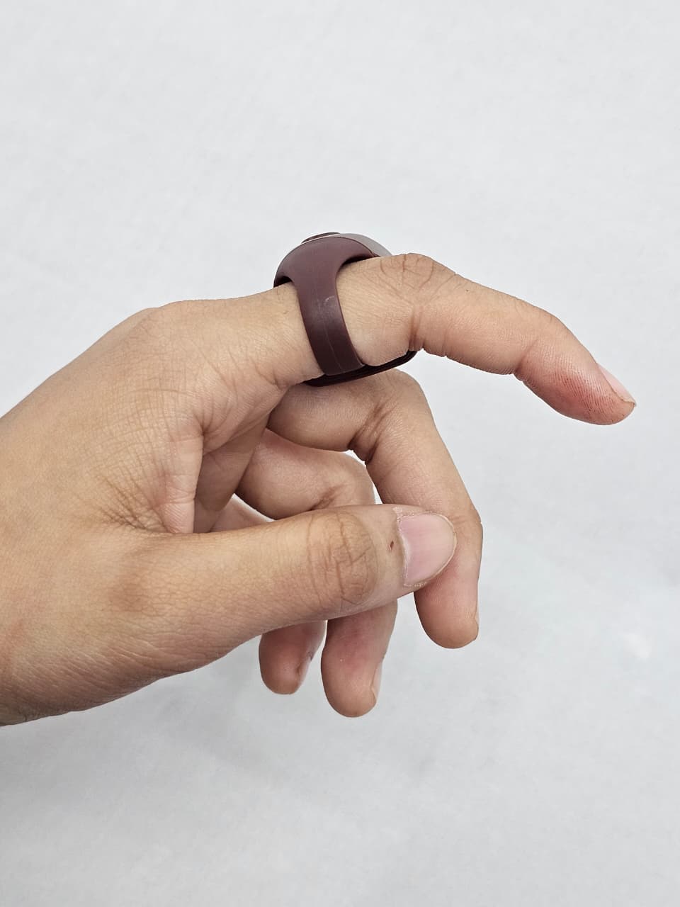 Compact brown plastic zikr counter with finger strap and LED display.