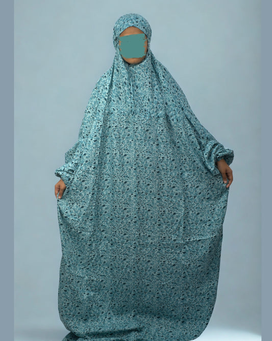 Full view of teal green floral prayer dress with elastic sleeves.