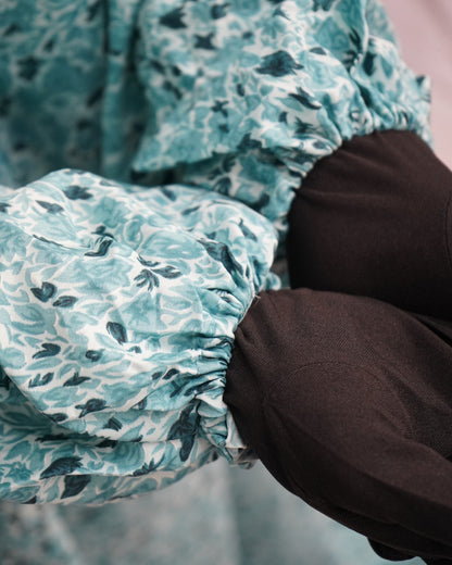 Sleeve detail showing elastic cuffs of teal green prayer dress.