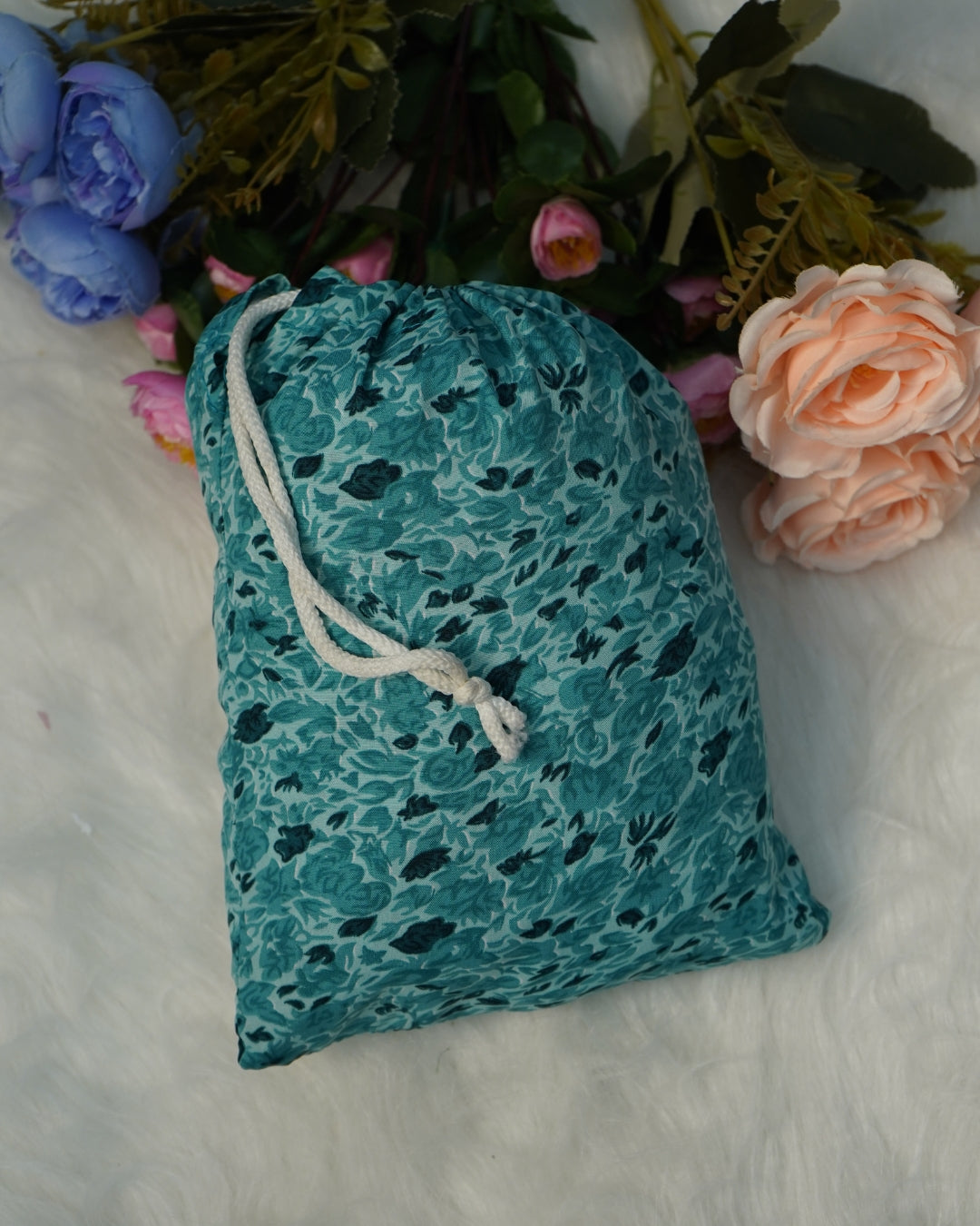 Compact teal green floral prayer dress packed in matching pouch.