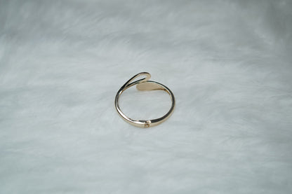 etailed view of gold cuff bracelet with modern sculptural tips.