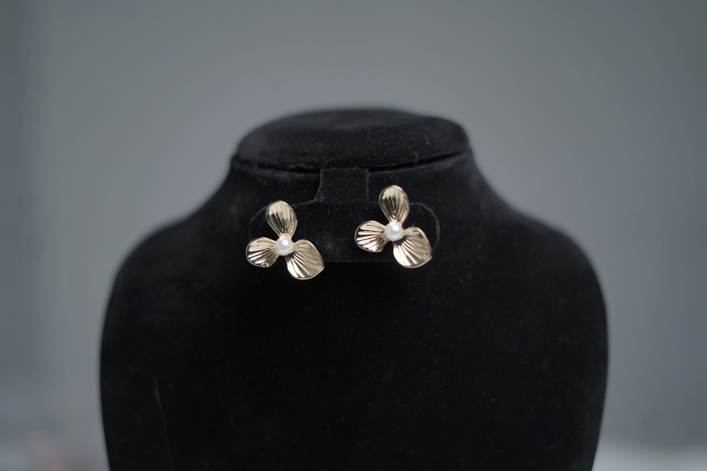Detailed zoom of antique finish and faux pearl.
