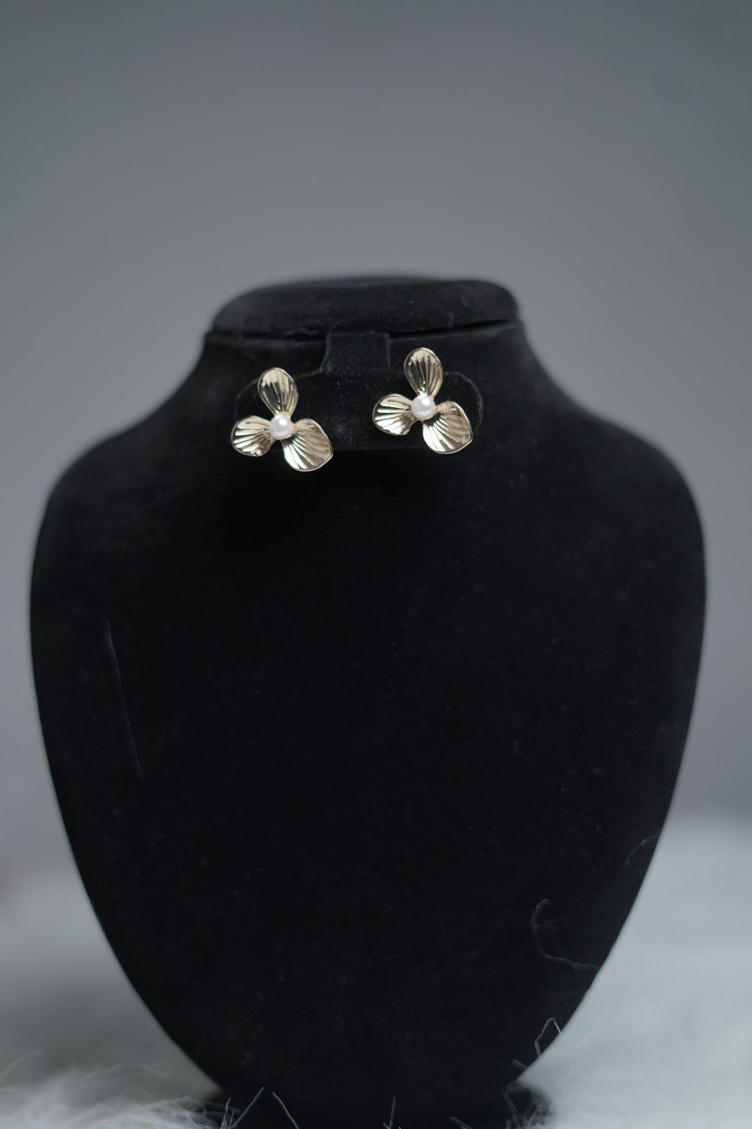 Vintage floral stud earrings displayed on earring stand.