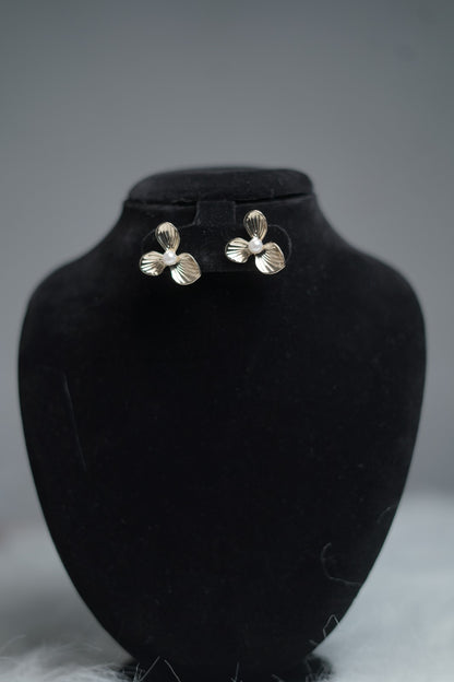Vintage floral stud earrings displayed on earring stand.