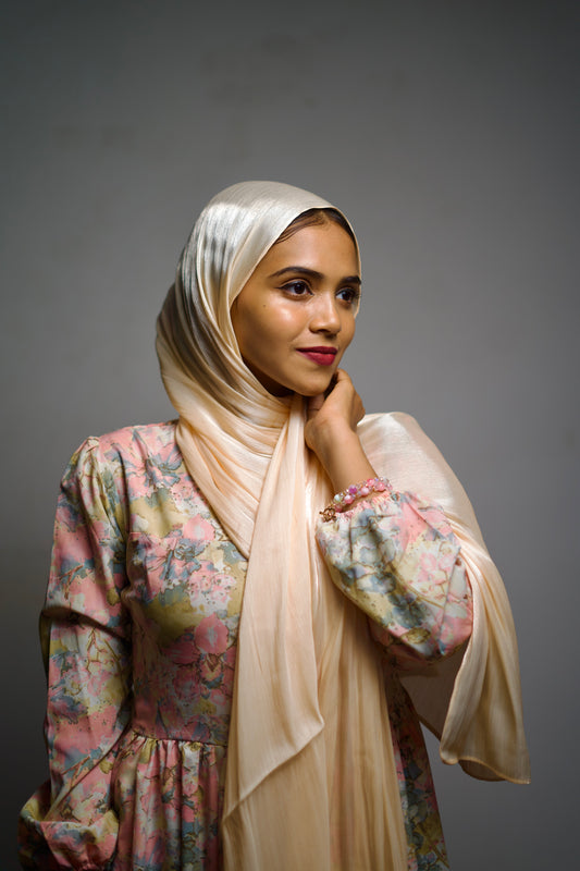 Shimmer chiffon hijab in wheat tone, styled naturally with a smooth wrap.