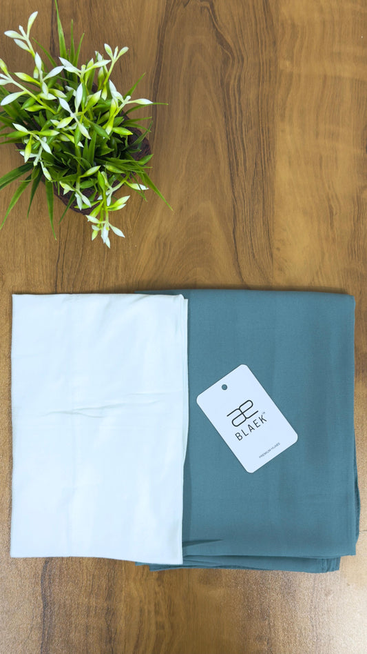 Soft mint green hijab with a crisp white cap.
