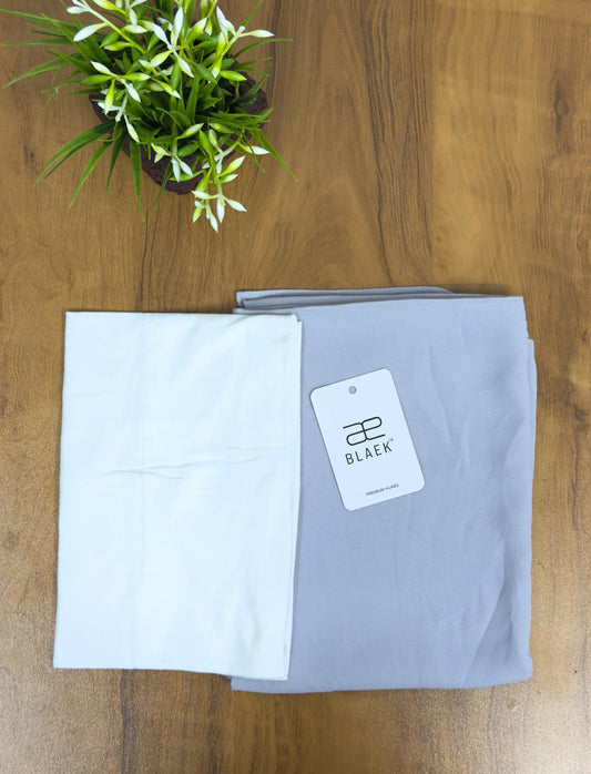 Soft silver hijab with a smooth white cap for a refined contrast.