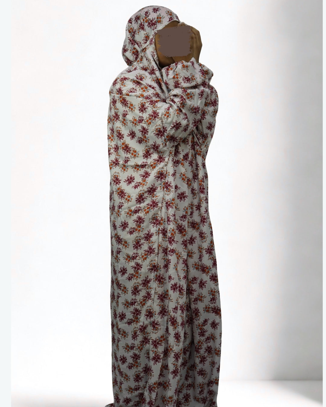 Woman wearing full-length white floral prayer dress with modest coverage.