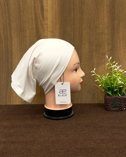 Mannequin with white tube cap, side profile view.