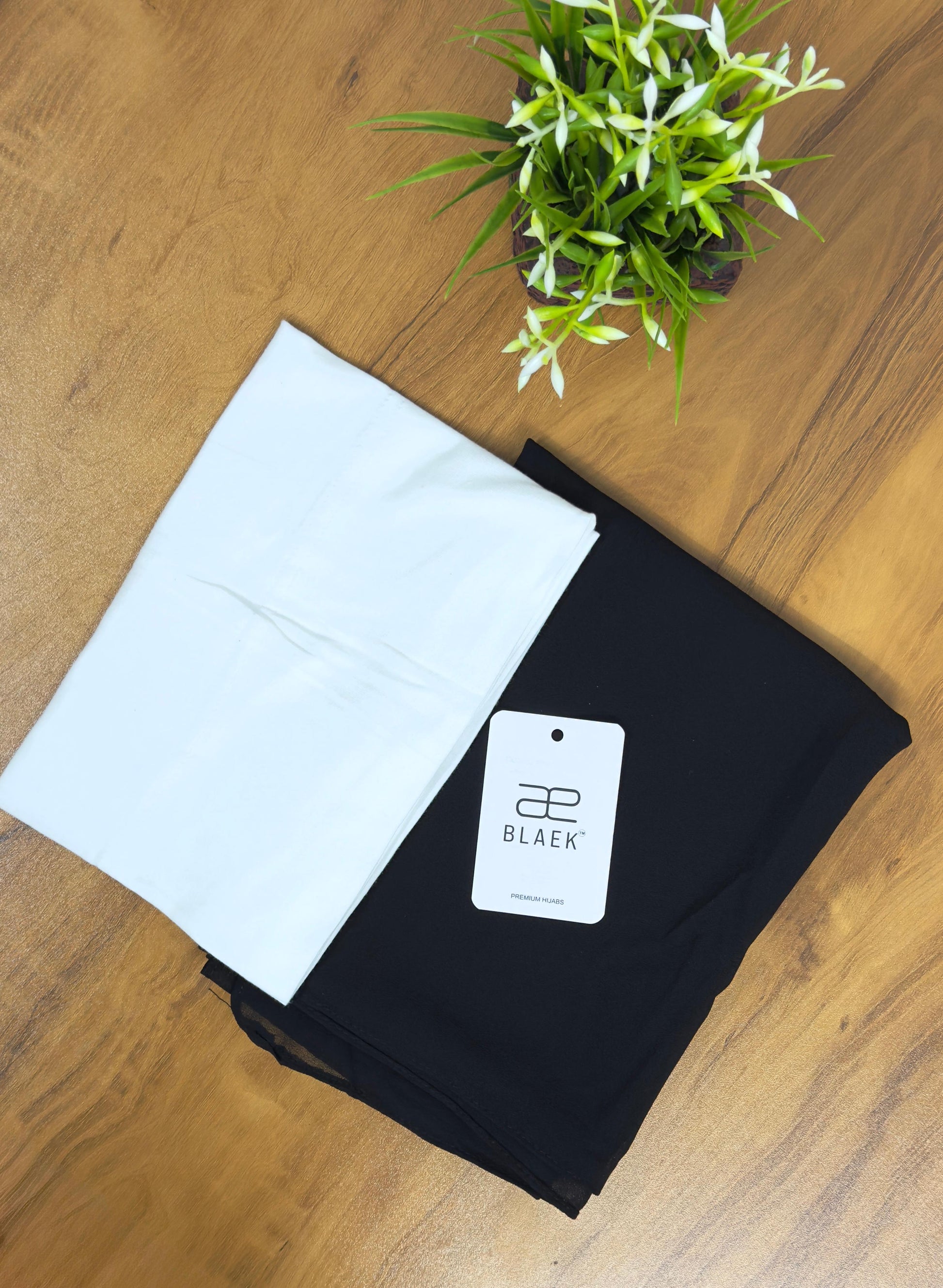 Stylish black slider hijab with a snug white cap for a polished fit.