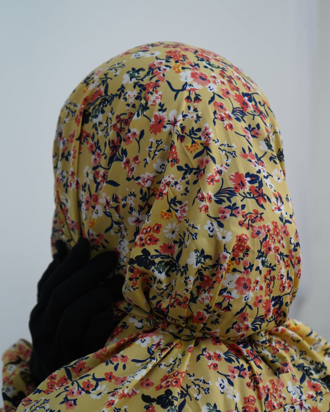 Close-up of yellow floral print prayer dress showing back tie detail.