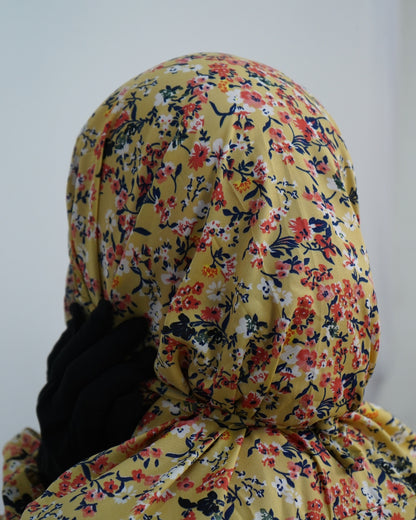 Close-up of yellow floral print prayer dress showing back tie detail.