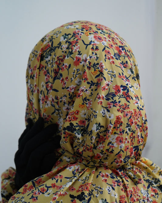 Close-up of yellow floral print prayer dress showing back tie detail.