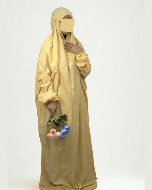 Woman wearing yellow polyester lycra prayer dress full body view.